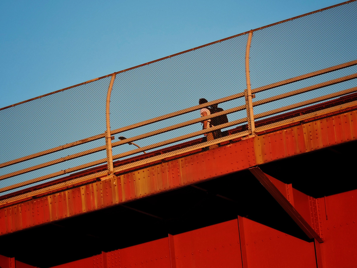 People crossing red bridge in Rego Park, Queens, near CORE Rego Park apts.