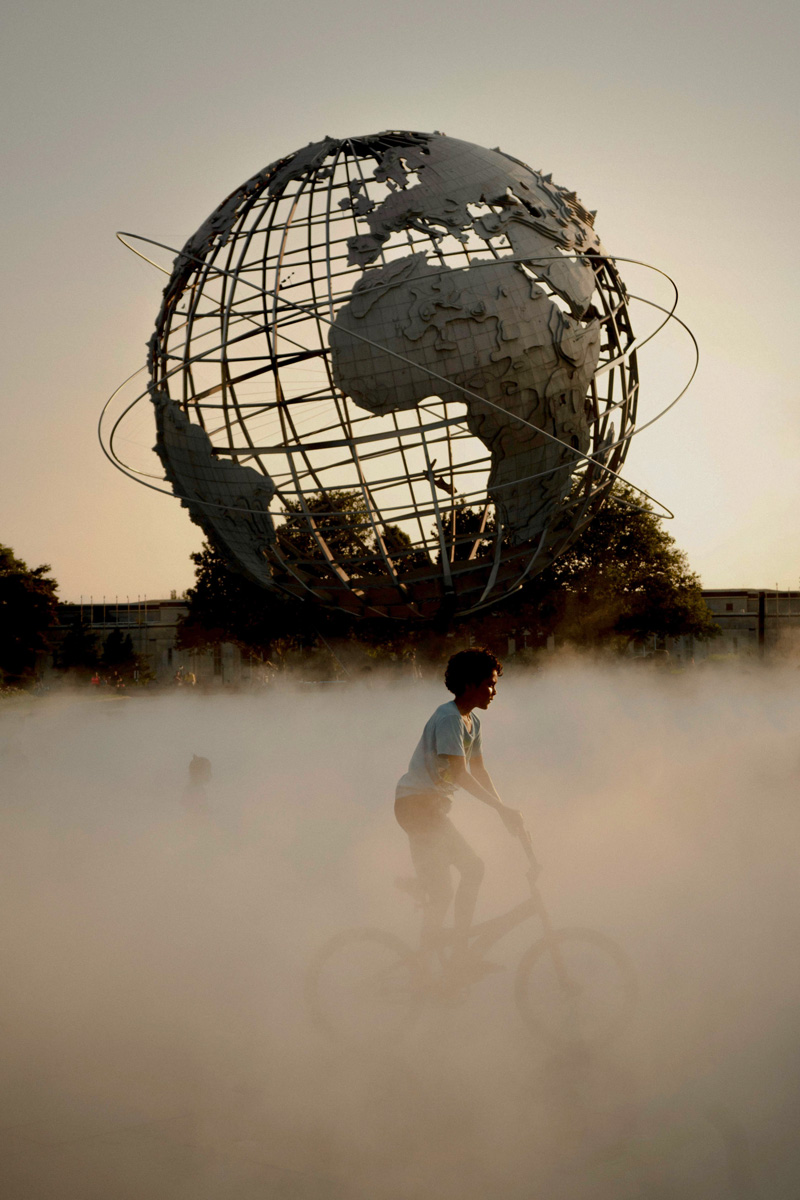 Cyclist and the iconic Unisphere in Flushing Meadows Corona Park, a landmark near CORE Rego Park apartments in Queens, NY.